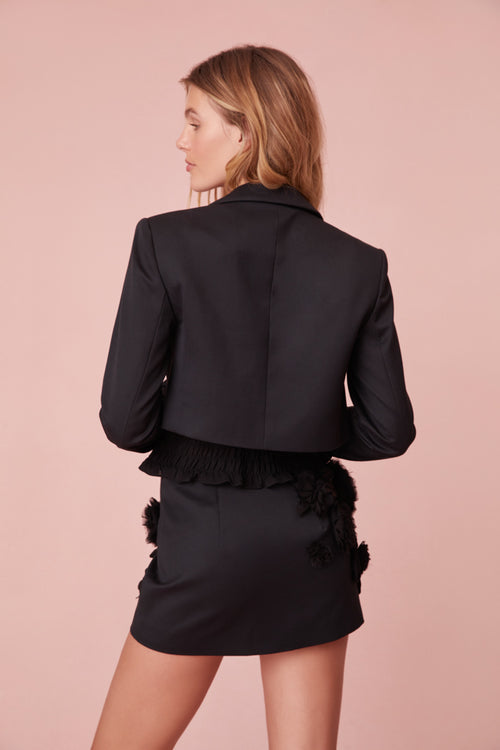 Black cropped blazer featuring handmade rosettes.