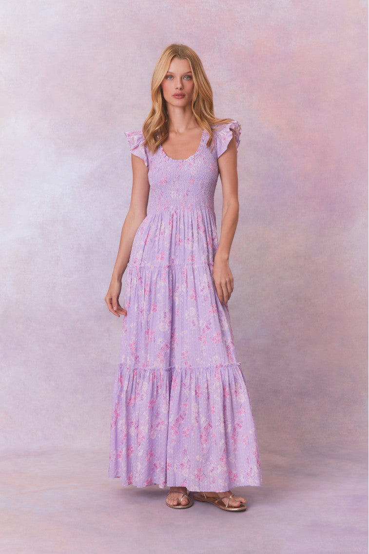 Purple floral print maxi dress with flutter sleeves and a tiered maxi skirt.