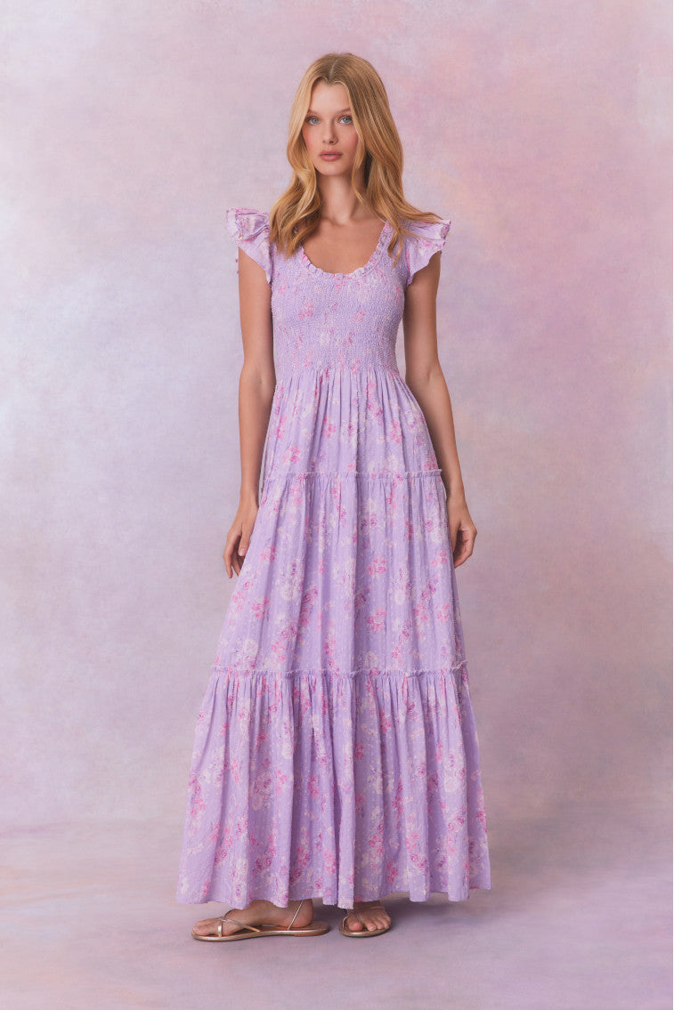 Purple floral print maxi dress with flutter sleeves and a tiered maxi skirt.