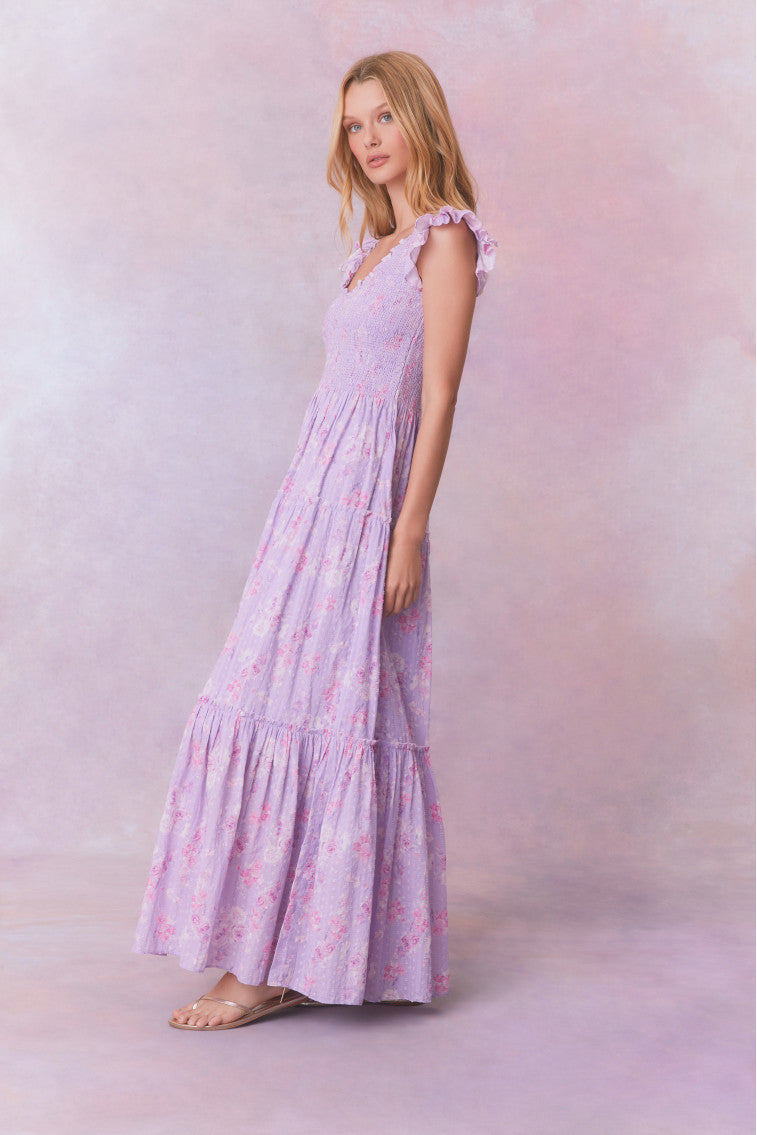 Purple floral print maxi dress with flutter sleeves and a tiered maxi skirt.