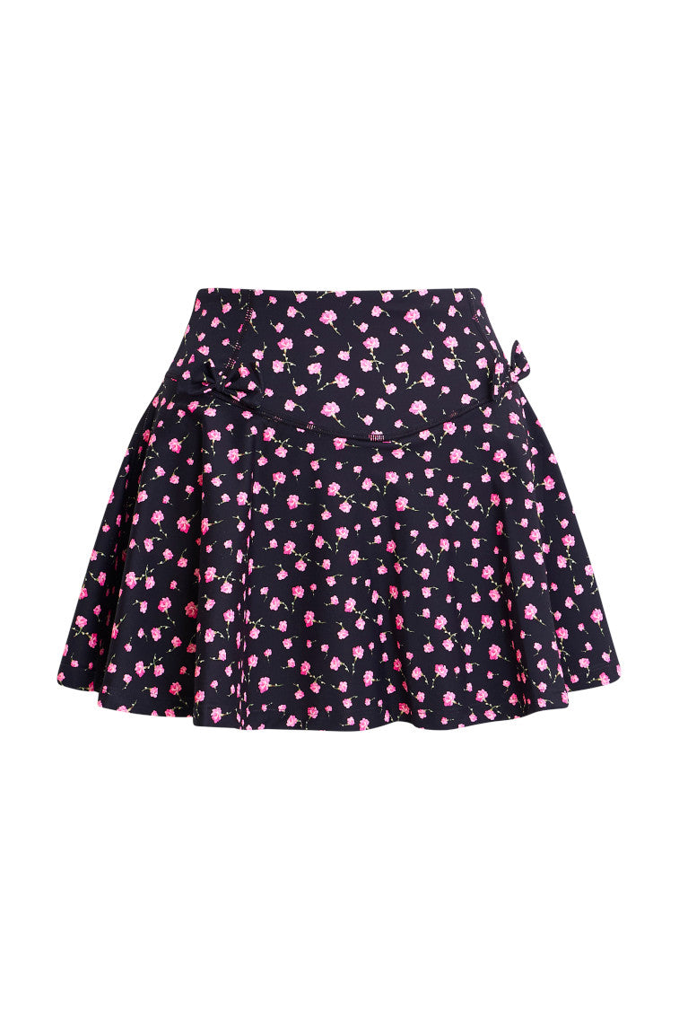 Black active skort with a pink floral pattern. Two patterned bows placed on each frontside of hip.