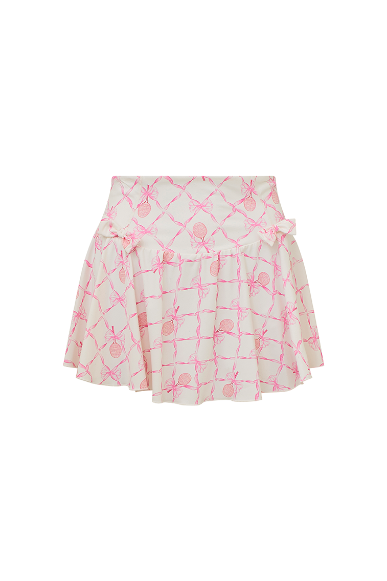 White active skort with a pink bow and tennis raquet pattern. Two patterned bows placed on each frontside of hip.
