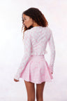 Pink active skort with a bow and tennis raquet pattern. Two pink bows placed on each frontside of hip.