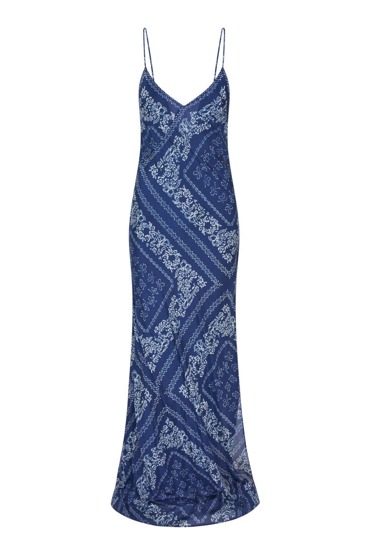 Slight form fitting blue bandana print silk habotai maxi dress&nbsp;with tiny spaghetti straps above a slight v-neckline, with a long skirt.