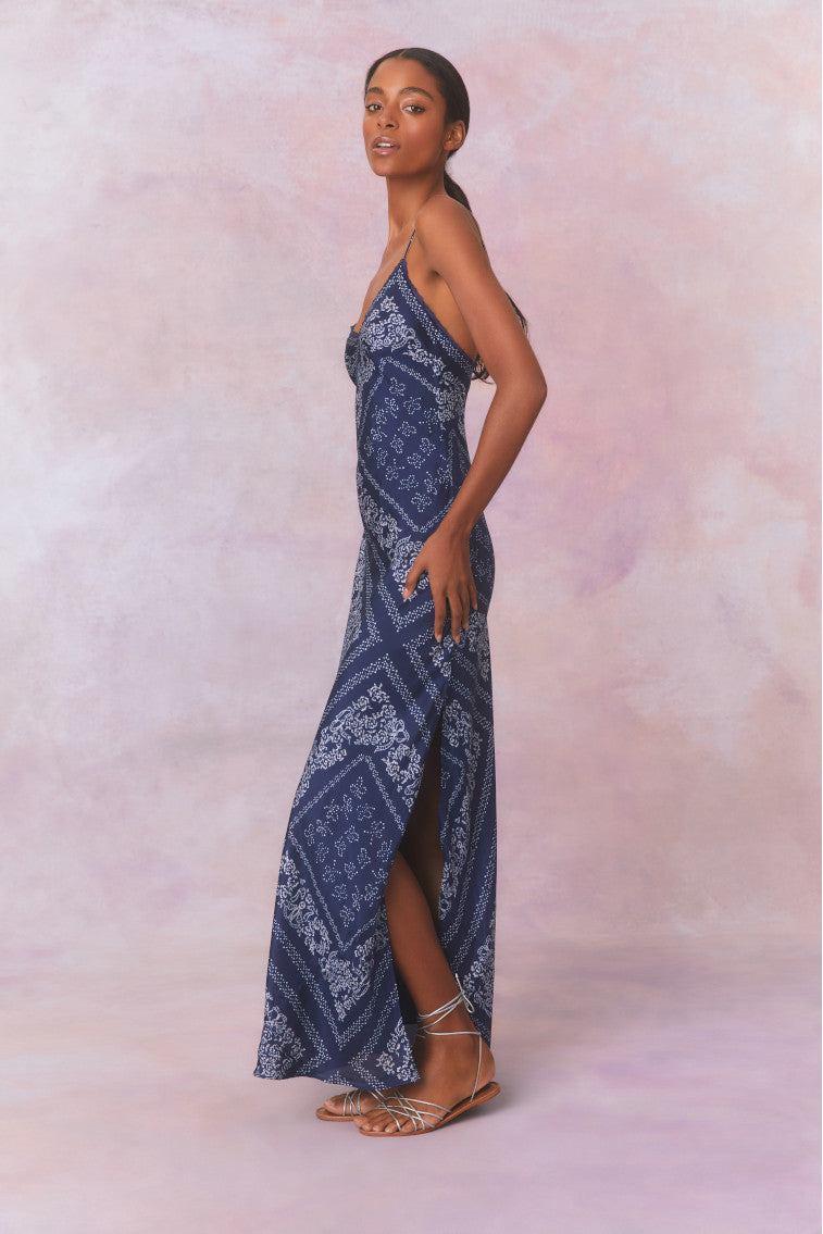 Slight form fitting blue bandana print silk habotai maxi dress&nbsp;with tiny spaghetti straps above a slight v-neckline, with a long skirt.