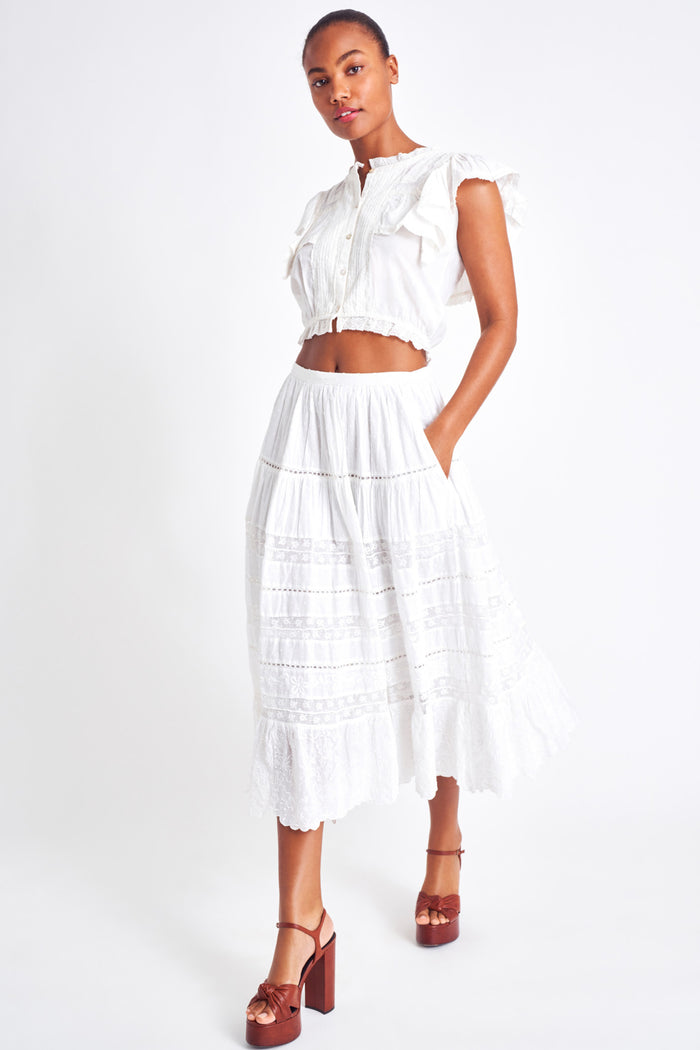 White midi skirt with lace detailing throughout the skirt as well as on the bottom trim