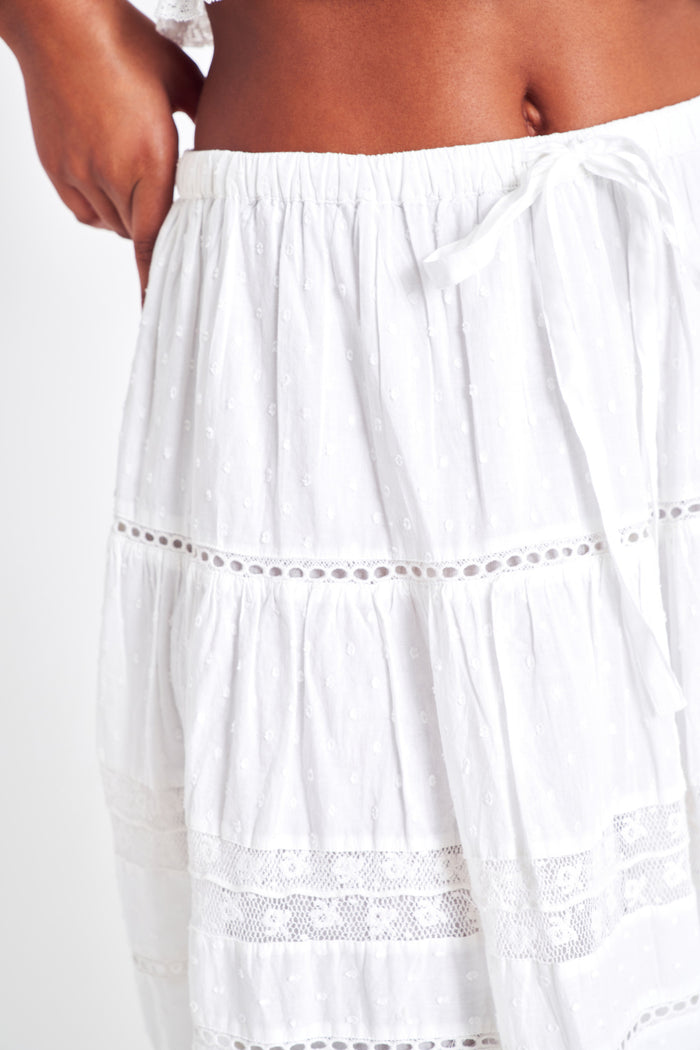 White midi skirt with lace detailing throughout the skirt as well as on the bottom trim