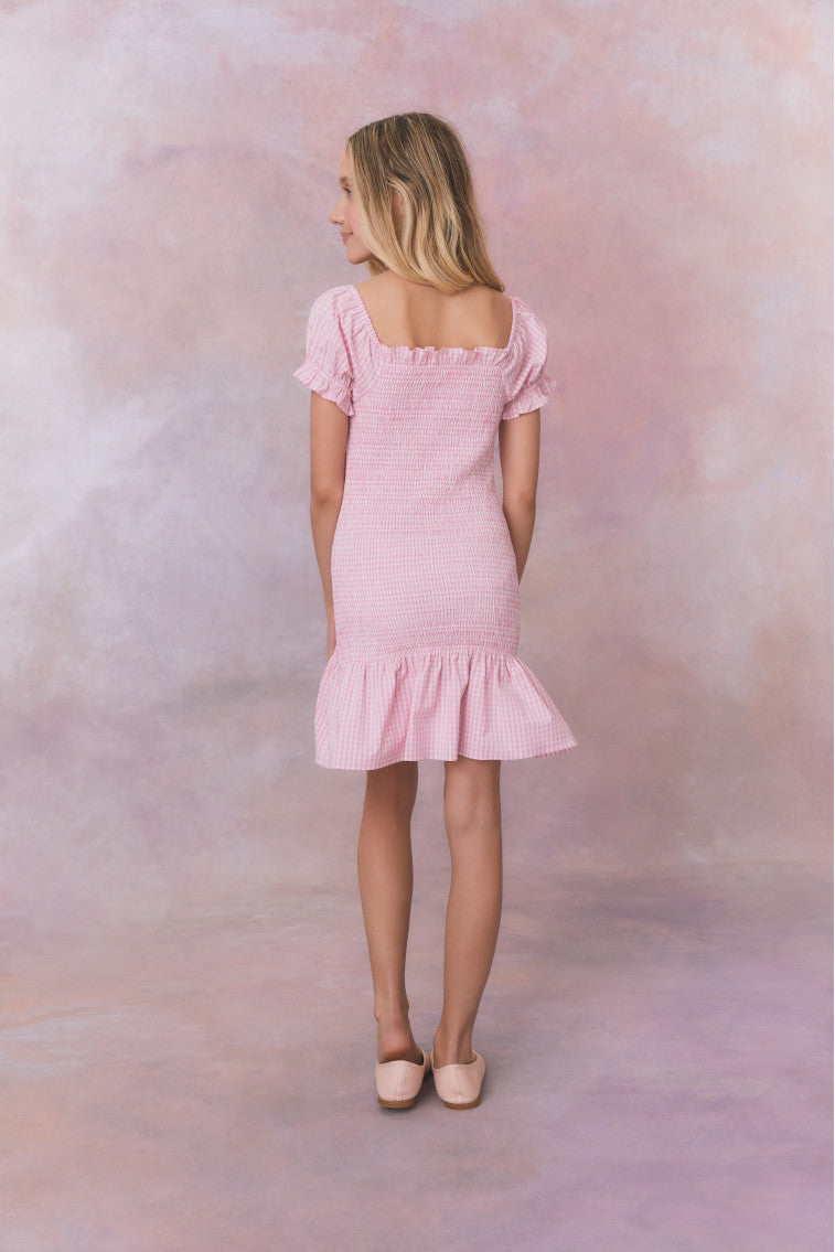 Pink gingham dress with short puff sleeves, a smocked bodice, and an airy skirt.