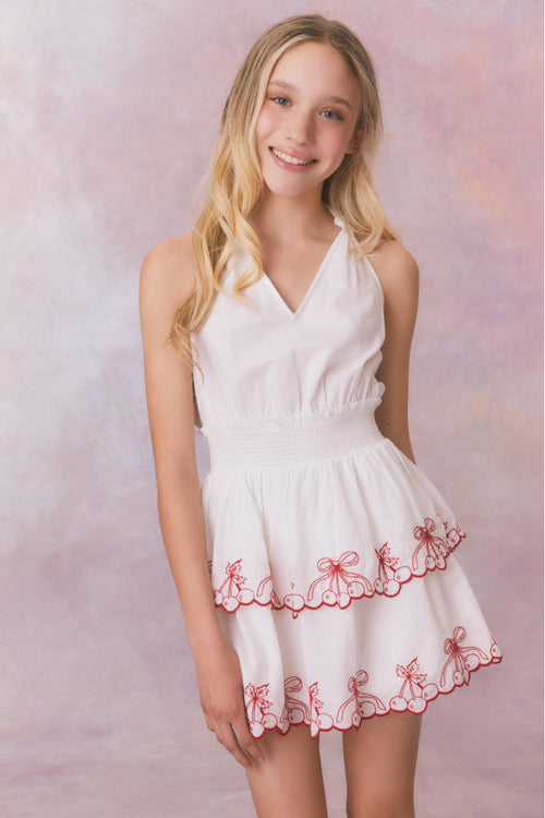 White halter v-neck dress with elastic waistband and cherry embroidery on the two tiered skirt for girls.