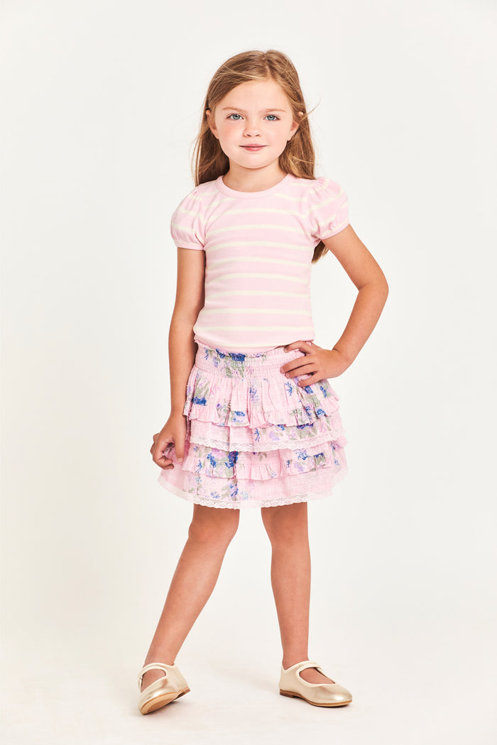 The Billie Skirt is 100% cotton and features a wide smocked waistband with two shirred tiers and ruffle detailing. It is a beautiful baby pink with blue flower detailing.  