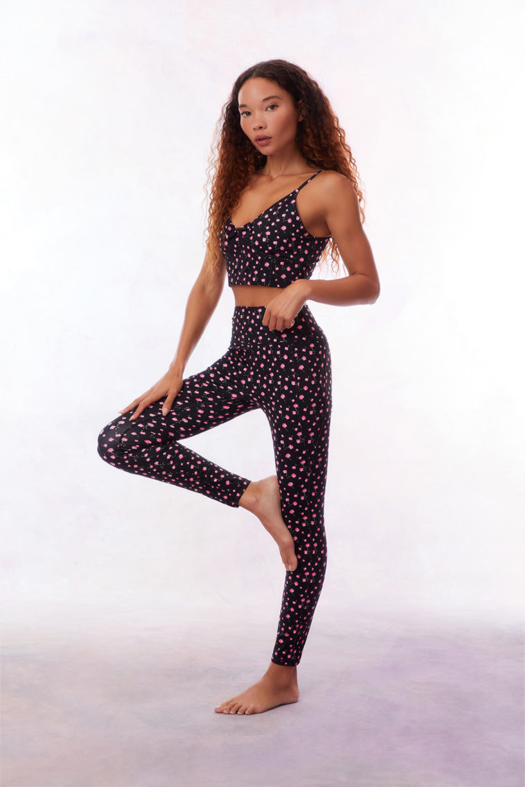 Black active legging with a pink floral pattern. 