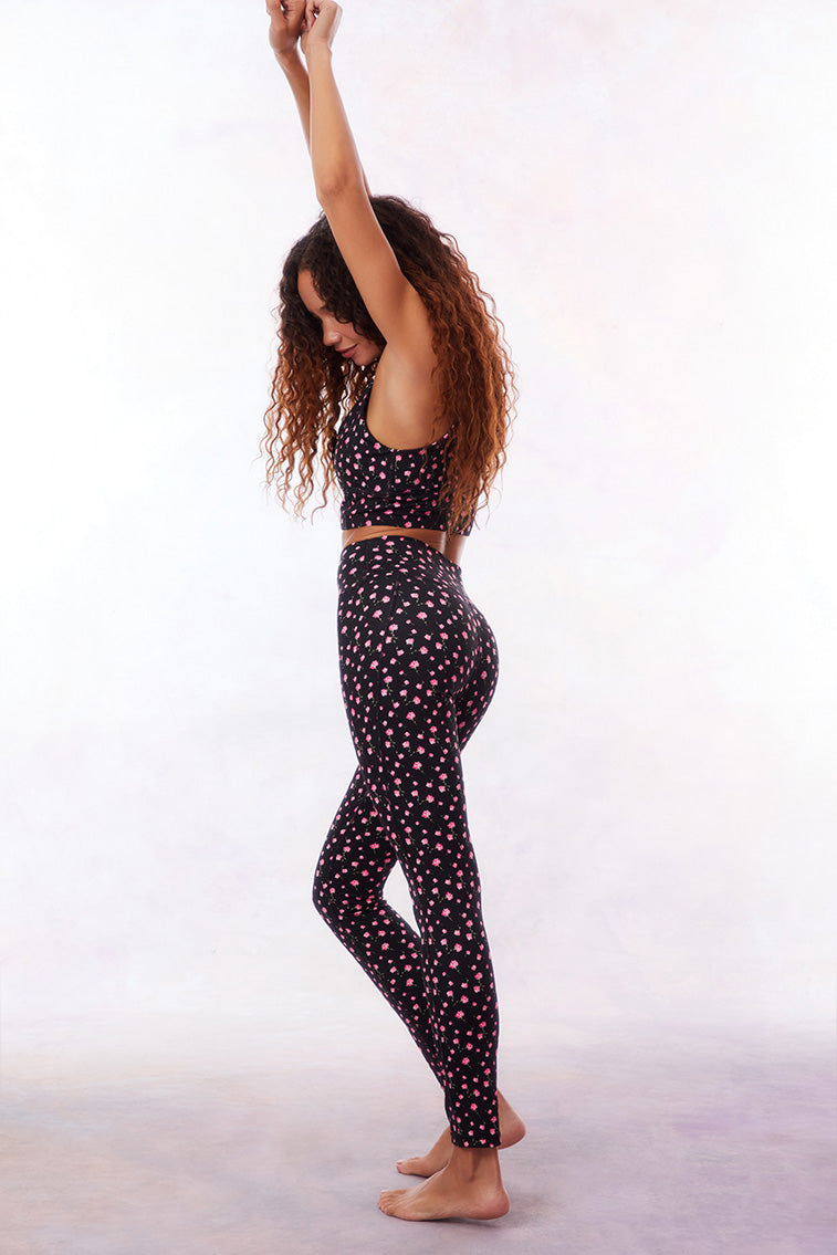 Black active legging with a pink floral pattern. 