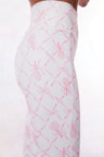 White active legging with a pink colored bow and tennis raquet pattern. 