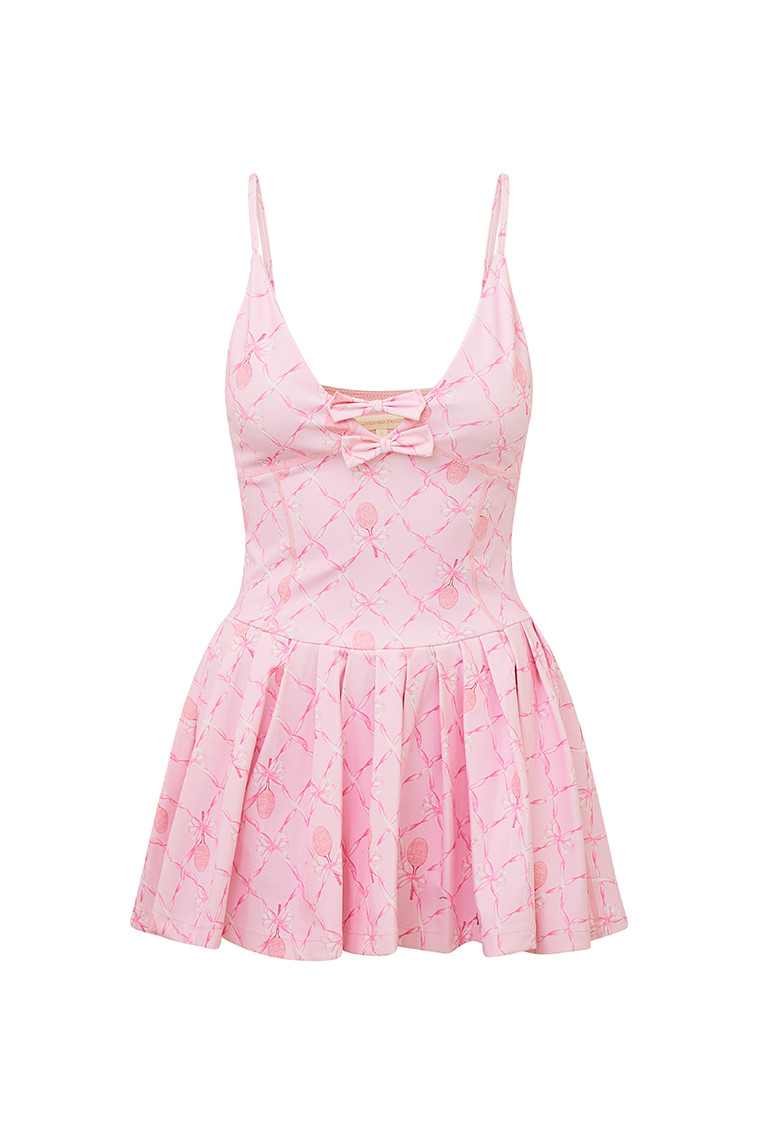 Pink airy active dress with built in shorts, a bow and tennis raquet pattern, and two bows at center front with a small keyhole at bust.