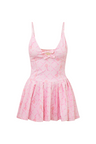 Pink airy active dress with built in shorts, a bow and tennis raquet pattern, and two bows at center front with a small keyhole at bust.