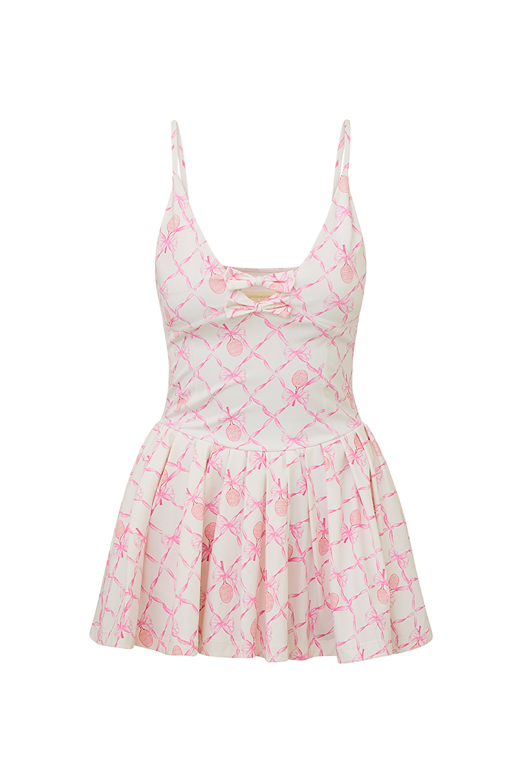 White airy active dress with built in shorts, a pink-colored bow and tennis raquet pattern, and two bows at center front with a small keyhole at bust.