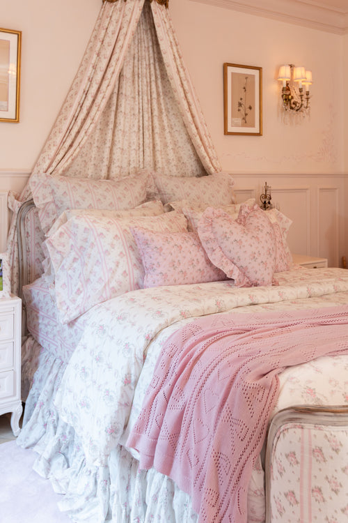 Pink, 100% cotton chic throw blanket. Featuring heart and bow-stripped pointelle details. 