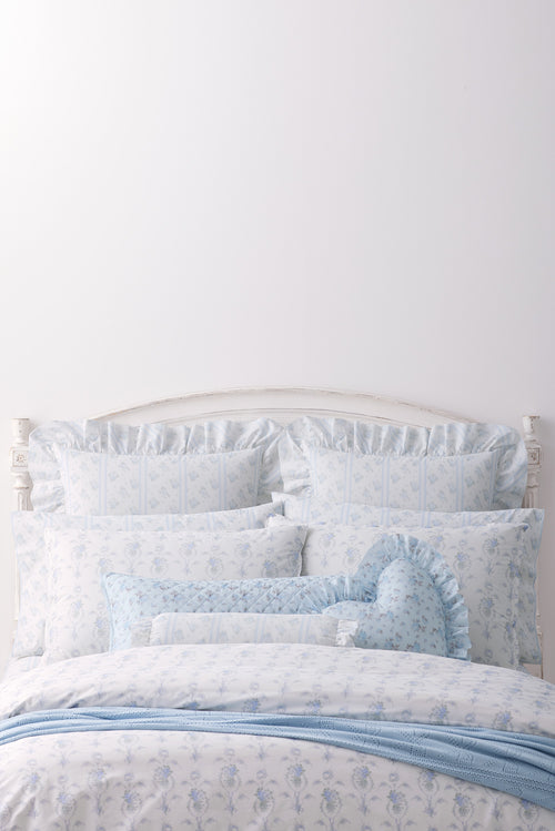 This dreamy ensemble features a delicate blue floral pattern on a pristine white backdrop. Crafted from 100% cotton