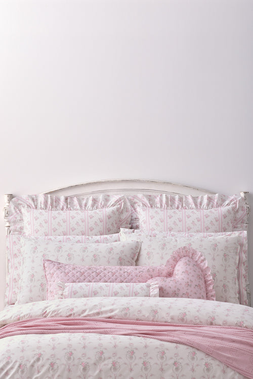 This dreamy ensemble features a delicate pink floral pattern on a pristine white backdrop. Crafted from 100% cotton