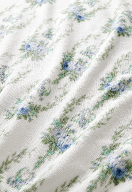 vintage-inspired repeating floral print bath towel in a soft blue against a white back