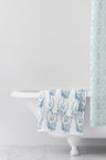 vintage-inspired repeating floral print bath towel in a soft blue against a white back