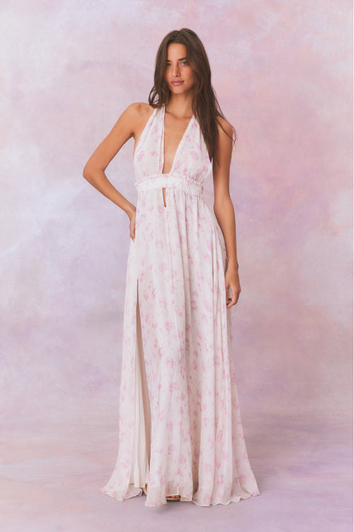 White backless floral halter maxi dress that ties in the back, flowing into an airy skirt.