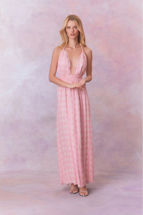 Pink floral halter maxi dress that ties in the back, flowing into an airy skirt.