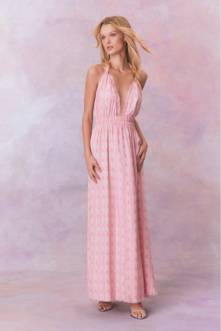 Pink floral halter maxi dress that ties in the back, flowing into an airy skirt.