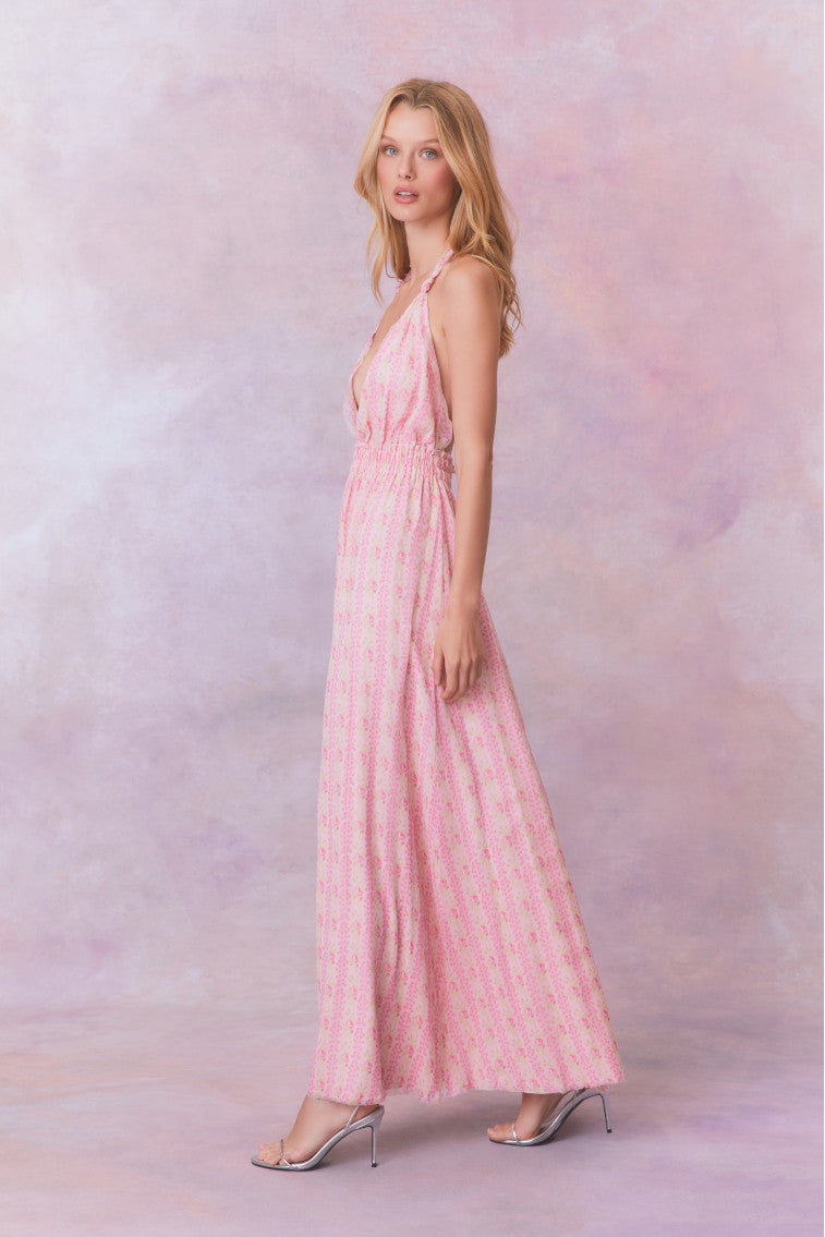 Pink floral halter maxi dress that ties in the back, flowing into an airy skirt.