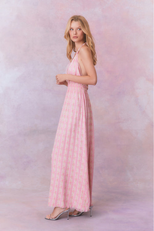 Pink floral halter maxi dress that ties in the back, flowing into an airy skirt.