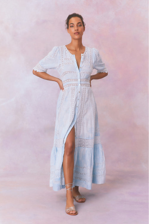 Blue cotton maxi dress with floral and lace detail, with buttons down center front, quarter length sleeves, a fixed waist, and a full sweeping skirt.