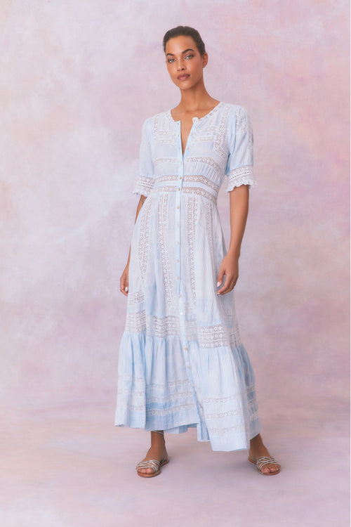 Blue cotton maxi dress with floral and lace detail, with buttons down center front, quarter length sleeves, a fixed waist, and a full sweeping skirt.