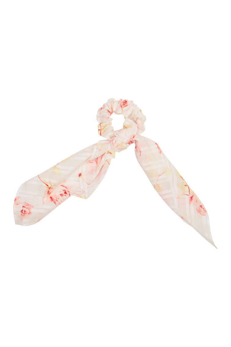 White scrunchie with light pink floral detail.