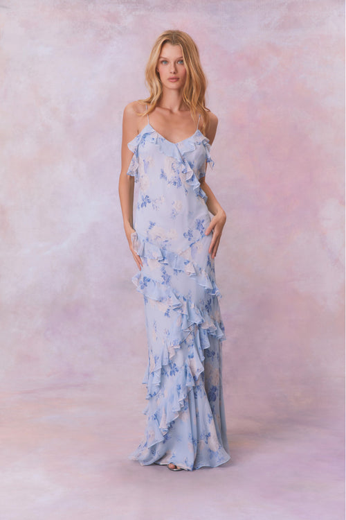 Blue floral chiffon maxi dress with spaghetti straps and ruffles that descend into the maxi skirt.