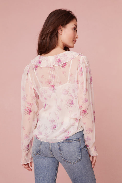 Long sleeve top in lavender floral print features a cascading design down the center front.