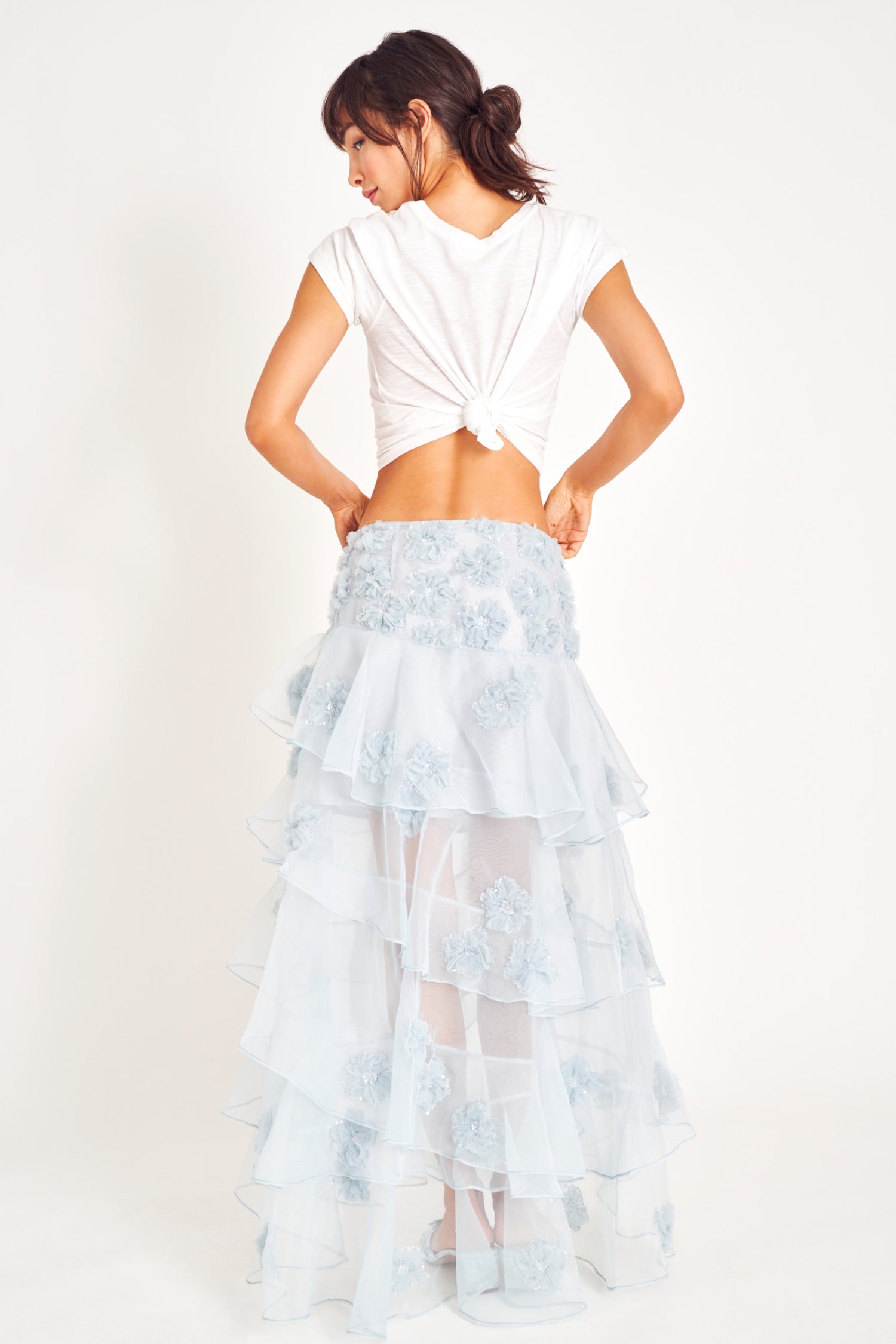 Voluminous tier blue maxi skirt with waist tie and embellishments.