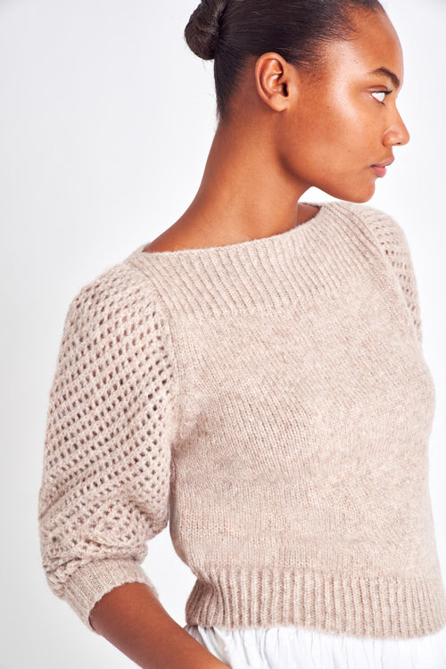 The Rosie oatmeal pullover is made from baby alpaca while being extremely light and full with a chunky look. It has a straight rib neckline and a straight body with rib finishing. It is an open knit weave with a puffy shoulder that slims out at the bottom. 