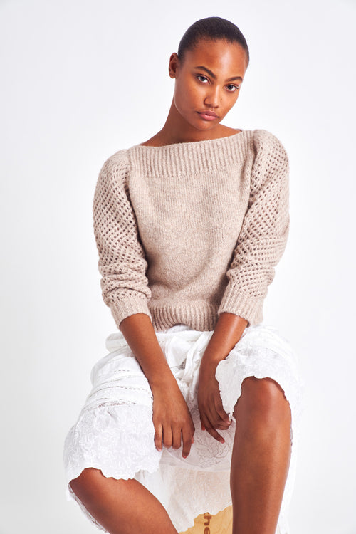 The Rosie oatmeal pullover is made from baby alpaca while being extremely light and full with a chunky look. It has a straight rib neckline and a straight body with rib finishing. It is an open knit weave with a puffy shoulder that slims out at the bottom. 